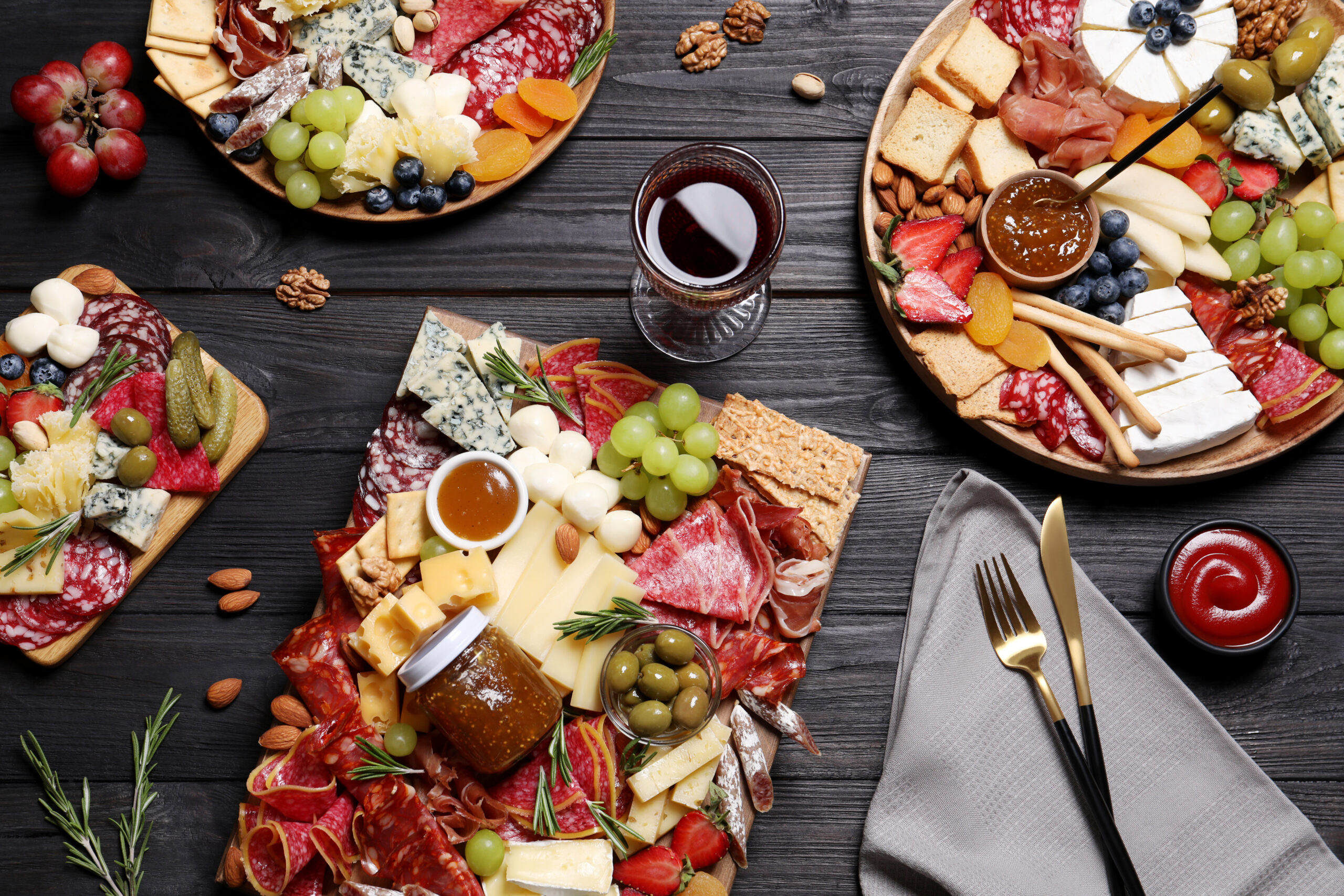 Assorted Grazing Boards with Cheese, Charcuterie, Nuts, Olives, Jam, Fresh Organic Fruit, Dried Fruit and Herbs